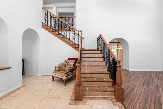 991 Clear Sky Pl, Simi Valley, CA 93065 - staircase with a high ceiling, arched walkways, and wood finished floors