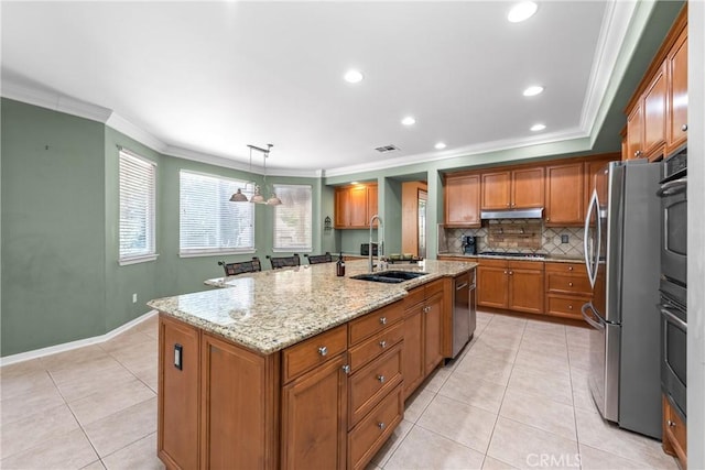 991 Clear Sky Pl, Simi Valley, CA 93065 - kitchen with ornamental molding, brown cabinetry, light tile patterned floors, appliances with stainless steel finishes, and a center island with sink