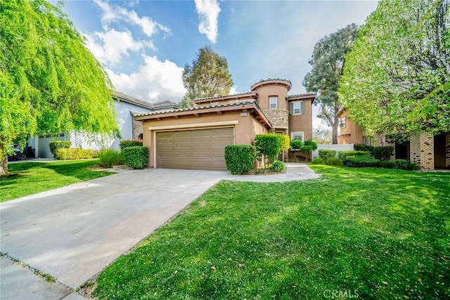 mediterranean / spanish home with a front yard, stucco siding, a tiled roof, and concrete driveway