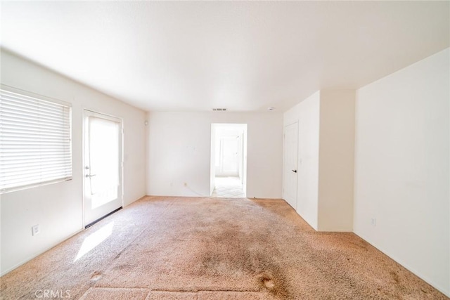spare room with light carpet and visible vents