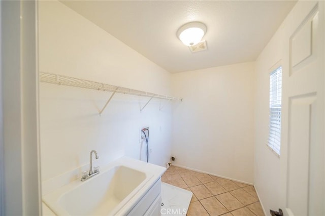 laundry area featuring washer hookup, visible vents, light tile patterned floors, and a sink