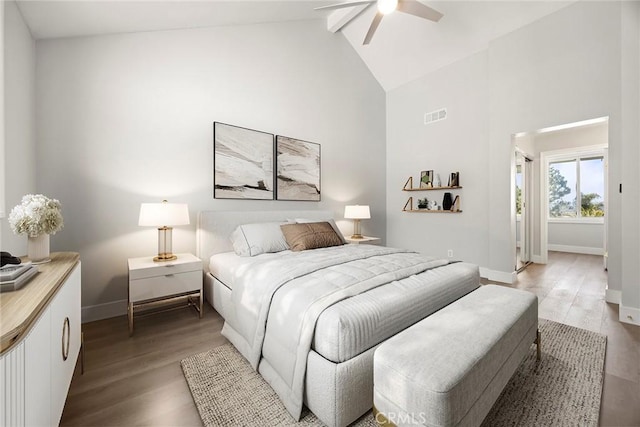 bedroom with light wood-style flooring, beam ceiling, baseboards, visible vents, and high vaulted ceiling