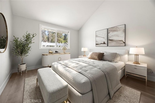 bedroom featuring vaulted ceiling, wood finished floors, and baseboards