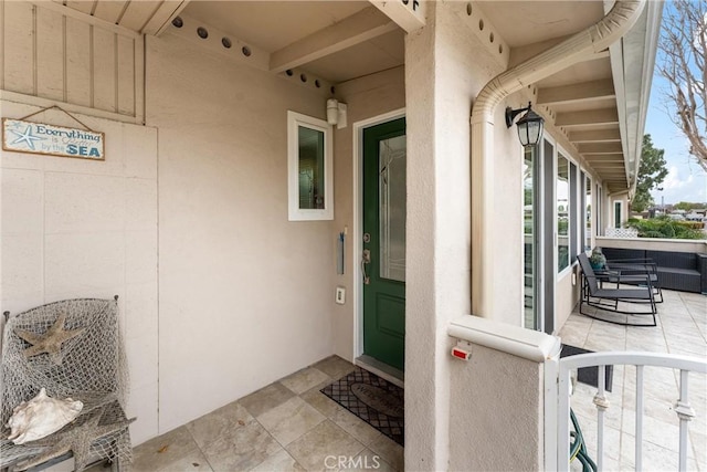 view of exterior entry featuring stucco siding