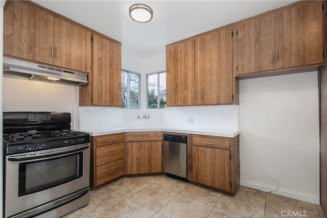 kitchen featuring backsplash, light countertops, appliances with stainless steel finishes, and under cabinet range hood