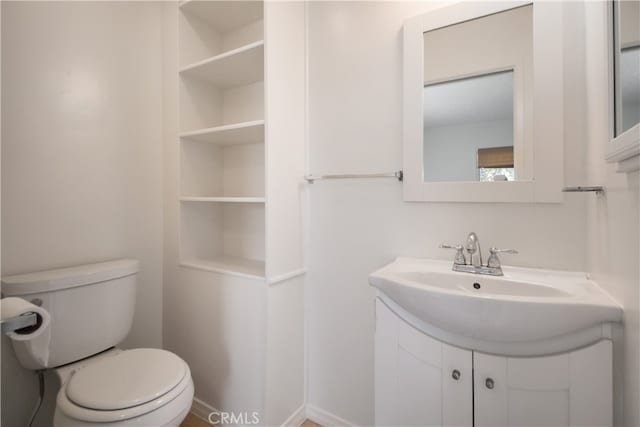 bathroom with toilet and vanity