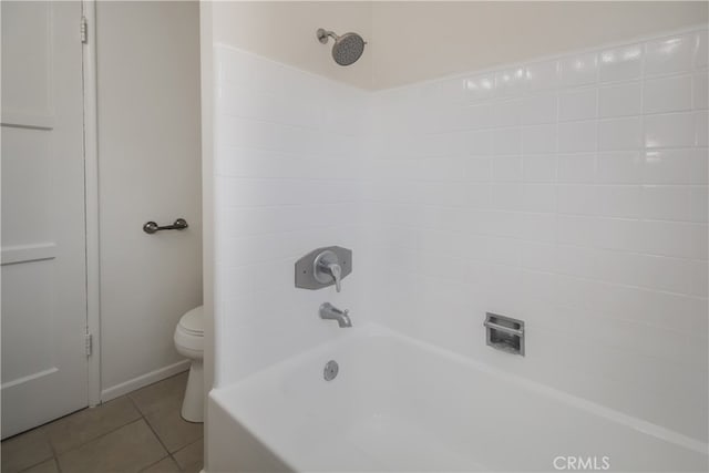 bathroom with toilet, shower / tub combination, and tile patterned flooring
