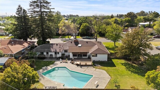 view of swimming pool with a lawn, fence, a patio area, and a fenced in pool