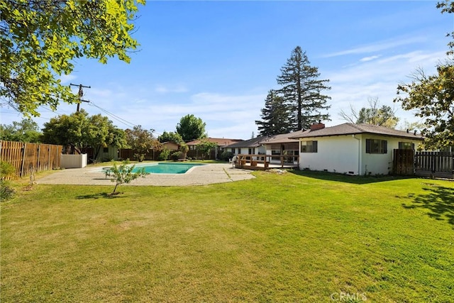 view of swimming pool featuring a fenced in pool, a lawn, a patio, and a fenced backyard