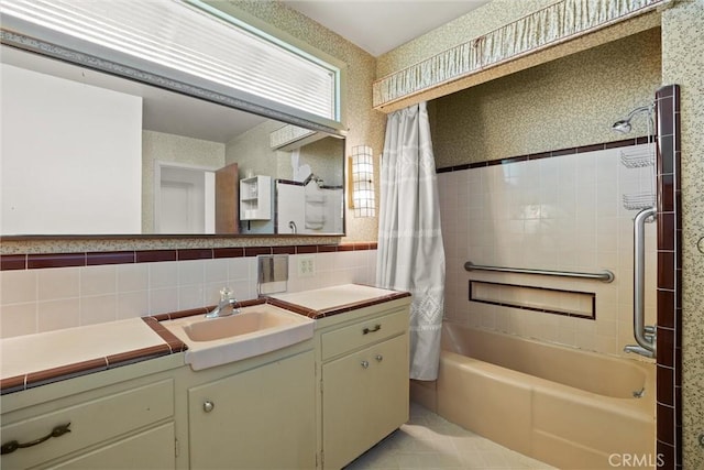 full bathroom with shower / bath combo, decorative backsplash, vanity, tile walls, and tile patterned flooring
