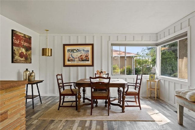 interior space featuring wood finished floors and a decorative wall