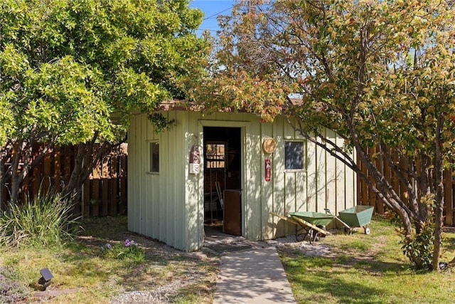 view of shed featuring fence
