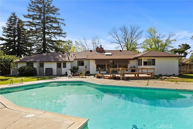 pool featuring fence, a patio area, and a deck