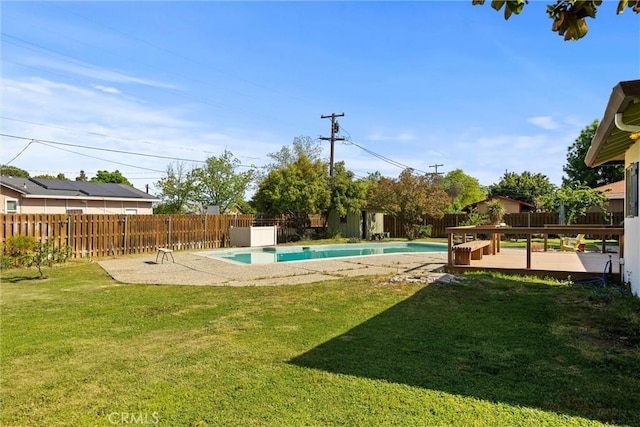 view of yard featuring a fenced in pool, a fenced backyard, and a deck
