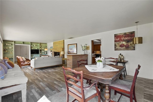 dining space featuring wood finished floors and visible vents