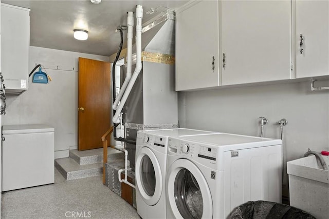 laundry area featuring cabinet space, washer and dryer, and a sink