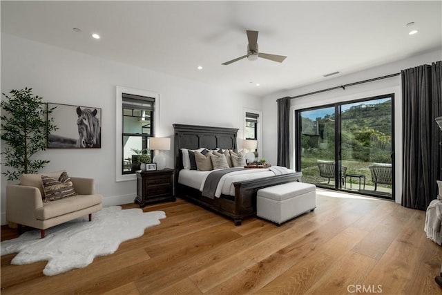 bedroom with recessed lighting, access to outside, light wood finished floors, and visible vents