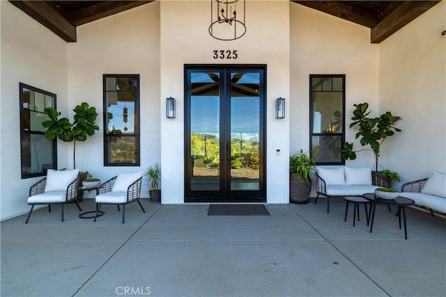 entrance to property with stucco siding and french doors