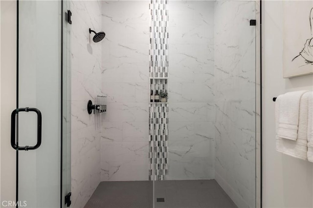 full bath with a marble finish shower