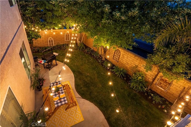 27705 Essex Pl, Valencia, CA 91354 - yard at night with a patio and a fenced backyard