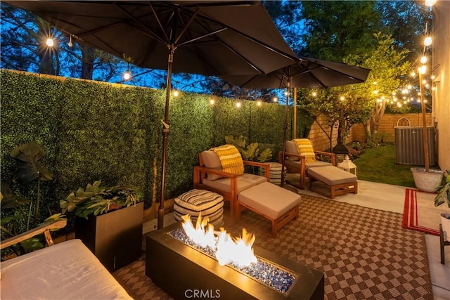 27705 Essex Pl, Valencia, CA 91354 - patio at night with an outdoor fire pit, a patio area, and a fenced backyard