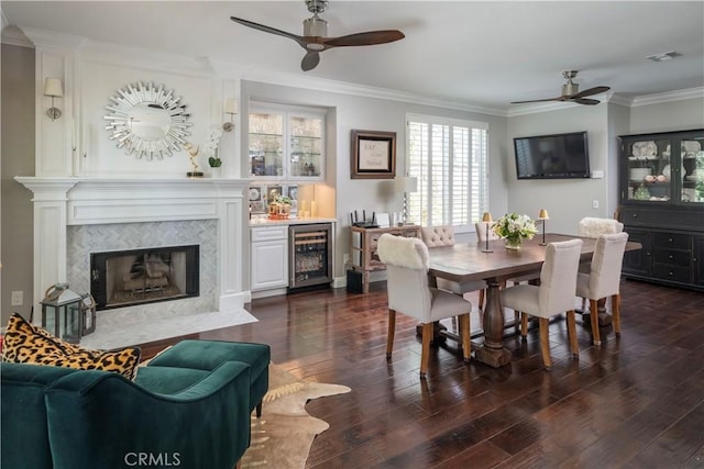 27705 Essex Pl, Valencia, CA 91354 - dining space featuring a ceiling fan, wine cooler, crown molding, dark wood-style flooring, and a dry bar