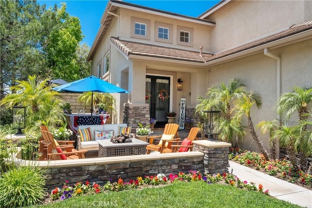 27705 Essex Pl, Valencia, CA 91354 - back of property with stucco siding, a patio area, stone siding, and an outdoor living space with a fire pit
