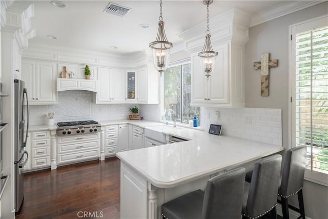27705 Essex Pl, Valencia, CA 91354 - kitchen featuring a peninsula, dark wood-style floors, white cabinets, stainless steel appliances, and light countertops