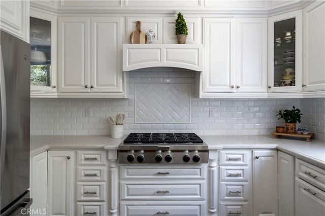 27705 Essex Pl, Valencia, CA 91354 - kitchen with appliances with stainless steel finishes, white cabinetry, light countertops, and backsplash