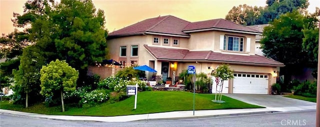 27705 Essex Pl, Valencia, CA 91354 - view of front facade featuring a tile roof, stucco siding, an attached garage, concrete driveway, and a front lawn