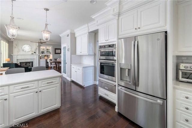 27705 Essex Pl, Valencia, CA 91354 - kitchen featuring appliances with stainless steel finishes, a warming drawer, plenty of natural light, ornamental molding, and light countertops