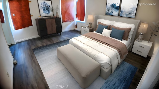 bedroom featuring baseboards and wood finished floors