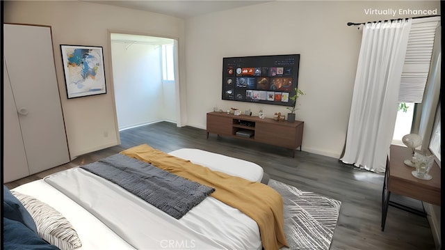 bedroom with wood finished floors and baseboards