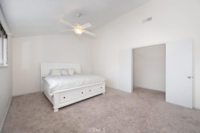 bedroom featuring visible vents, ceiling fan, vaulted ceiling, and carpet floors