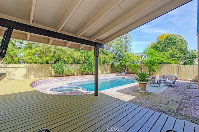 view of swimming pool with a deck, a patio area, an in ground hot tub, and a fenced backyard