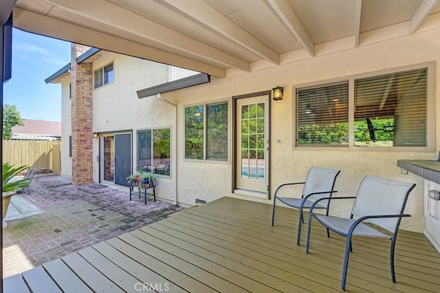 deck featuring a patio area and fence