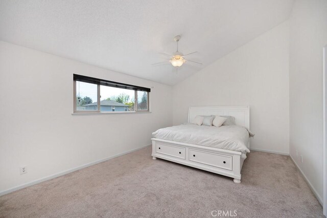 carpeted bedroom featuring baseboards, a ceiling fan, and lofted ceiling