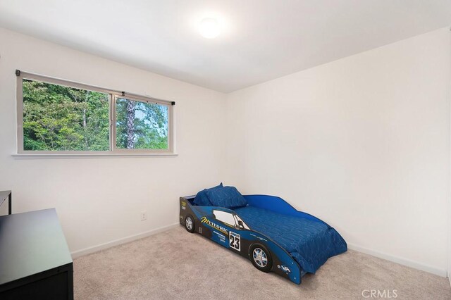 unfurnished bedroom featuring baseboards and carpet floors