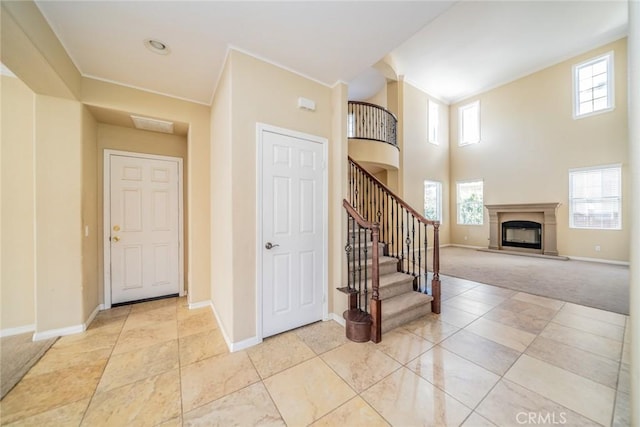 36368 Par Ln, Beaumont, CA 92223 - entrance foyer featuring plenty of natural light, baseboards, a glass covered fireplace, and a towering ceiling