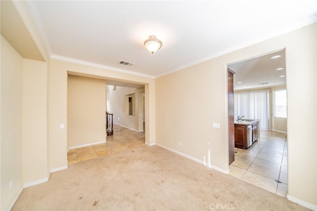 36368 Par Ln, Beaumont, CA 92223 - empty room featuring ornamental molding, light colored carpet, baseboards, light tile patterned flooring, and a sink
