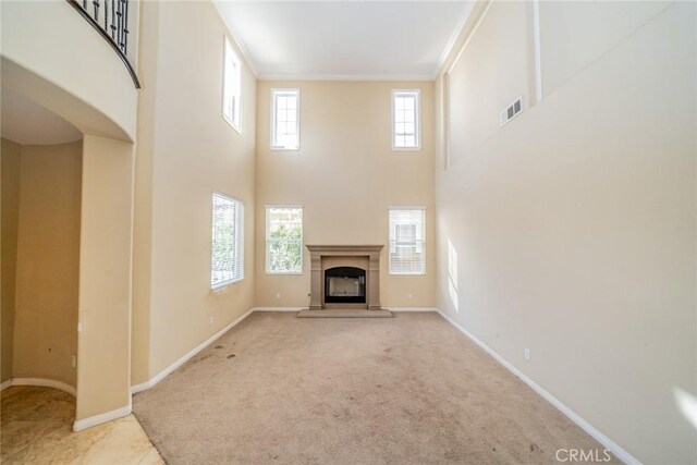 36368 Par Ln, Beaumont, CA 92223 - unfurnished living room featuring a high ceiling, carpet, a fireplace, baseboards, and ornamental molding