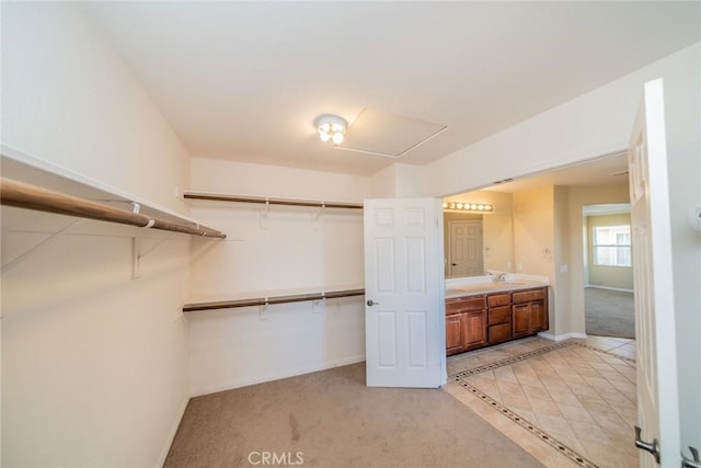 36368 Par Ln, Beaumont, CA 92223 - walk in closet with light carpet, a sink, and light tile patterned floors