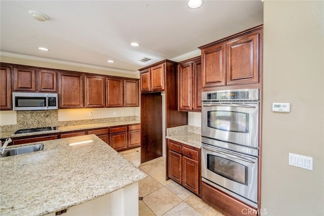 36368 Par Ln, Beaumont, CA 92223 - kitchen with appliances with stainless steel finishes, crown molding, recessed lighting, light stone counters, and light tile patterned floors