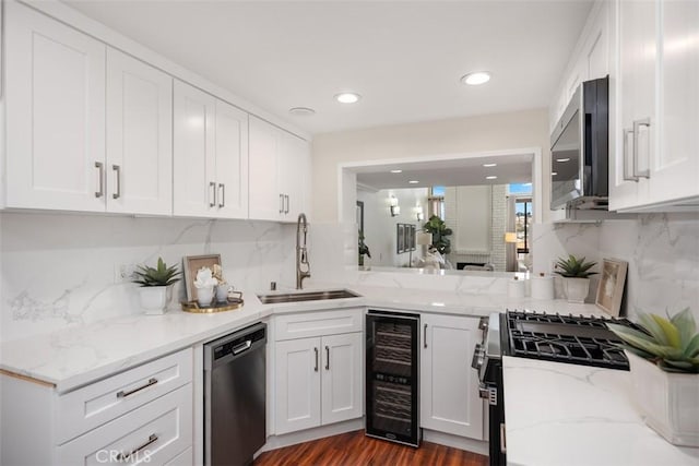 27869 Mazagon Unit 111, Mission Viejo, CA 92692 - kitchen with appliances with stainless steel finishes, beverage cooler, a sink, white cabinets, and decorative backsplash
