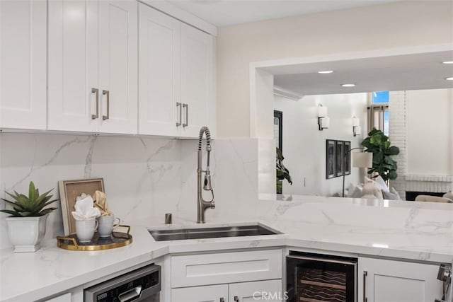 27869 Mazagon Unit 111, Mission Viejo, CA 92692 - kitchen with beverage cooler, a sink, tasteful backsplash, and white cabinetry