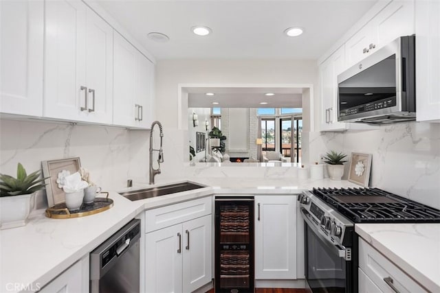 27869 Mazagon Unit 111, Mission Viejo, CA 92692 - kitchen featuring appliances with stainless steel finishes, wine cooler, a sink, white cabinets, and recessed lighting