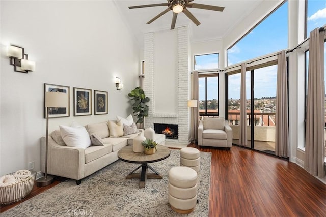 27869 Mazagon Unit 111, Mission Viejo, CA 92692 - living room with wood finished floors, a high ceiling, a ceiling fan, ornamental molding, and a fireplace