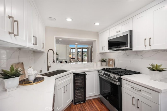 27869 Mazagon Unit 111, Mission Viejo, CA 92692 - kitchen with stainless steel appliances, wine cooler, a sink, white cabinetry, and decorative backsplash