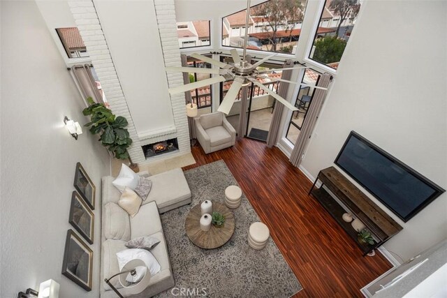 27869 Mazagon Unit 111, Mission Viejo, CA 92692 - living room with wood finished floors, healthy amount of natural light, a fireplace, and a ceiling fan