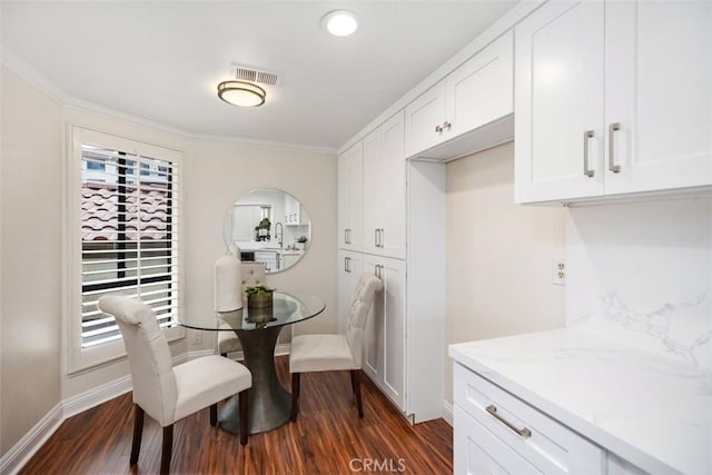 27869 Mazagon Unit 111, Mission Viejo, CA 92692 - dining space with dark wood-style floors, baseboards, and crown molding